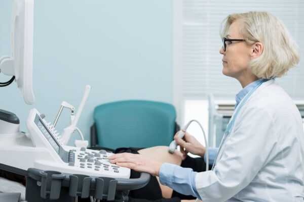 A nurse taking an ultrasound of a pregnant woman